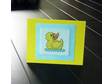 This cross stitch card features a bright yellow duck